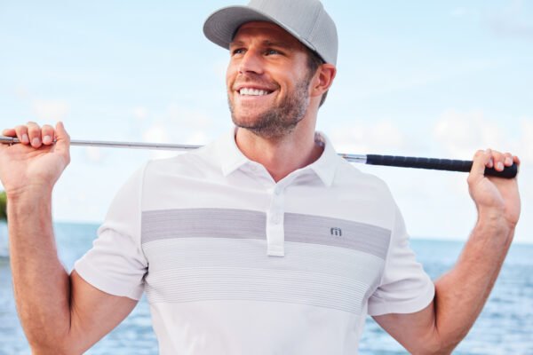 28079-7-TM1MY402WhiteModelLifestyleSP23-1200W TravisMathew Coastal Chest Stripe Polo